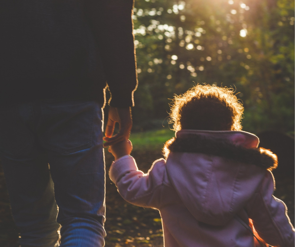 Young Kid Held by a Parent Outdoors